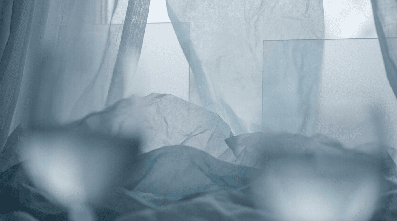 Layered translucent materials in soft blue and white light, creating ethereal, calming abstract texture.