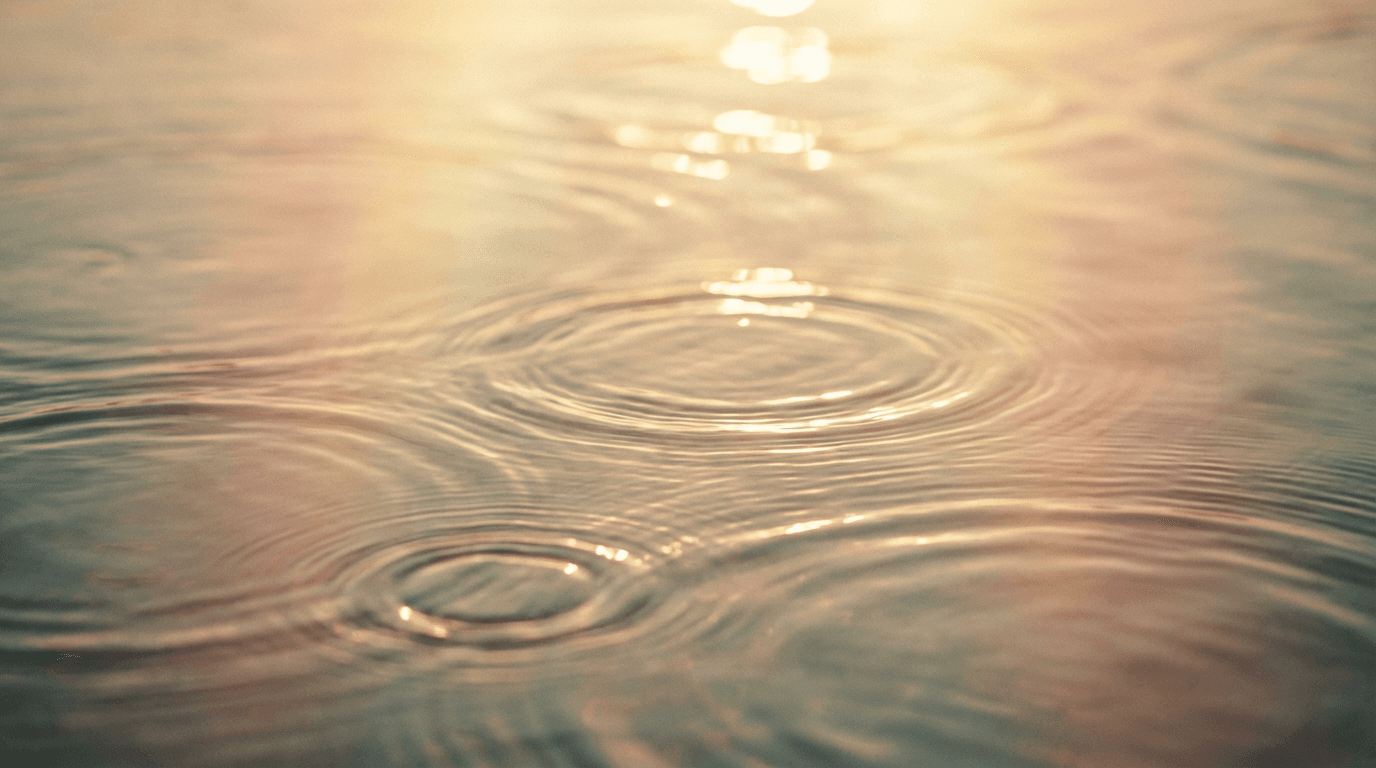 Serene water surface with subtle ripples and soft light reflections, conveying peaceful spiritual clarity and meditative tranquility.